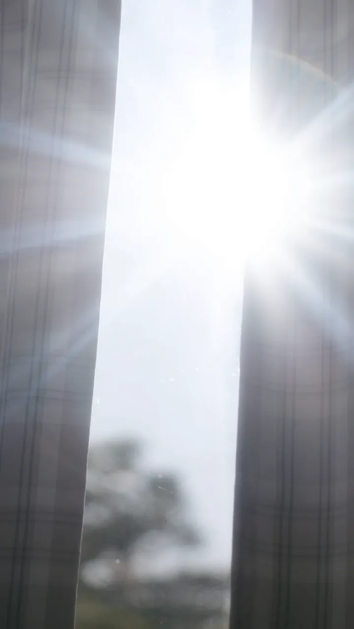 Sunlight pouring through a gap in the curtains